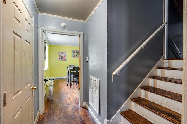 stairs with ornamental molding and wood-type flooring