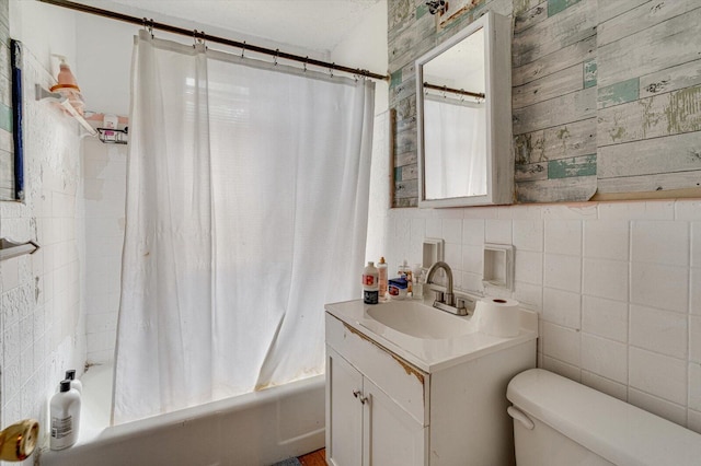 full bathroom featuring vanity, toilet, shower / bath combination with curtain, and tile walls