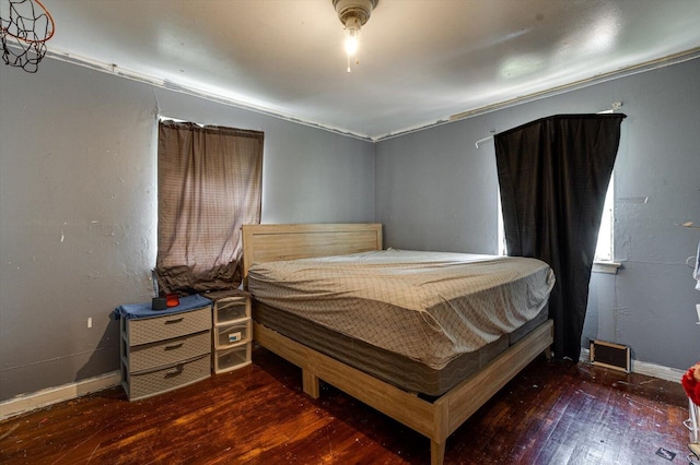 bedroom featuring dark wood-type flooring and ornamental molding