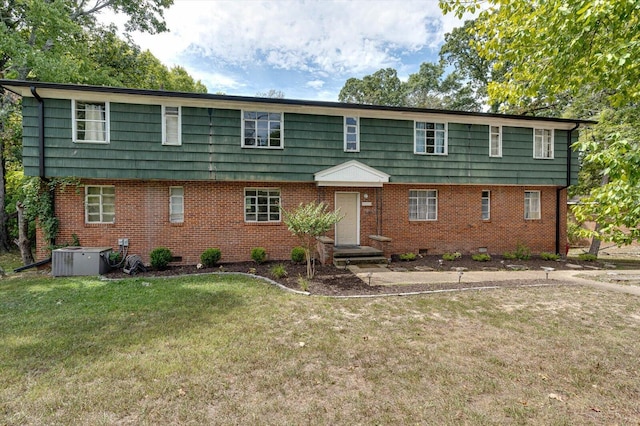 view of front of house with a front lawn and central AC