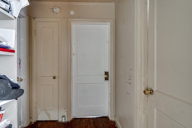 interior space featuring ornamental molding and dark hardwood / wood-style flooring