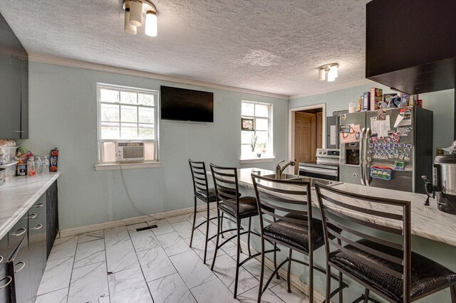 interior space with cooling unit, plenty of natural light, crown molding, and a textured ceiling