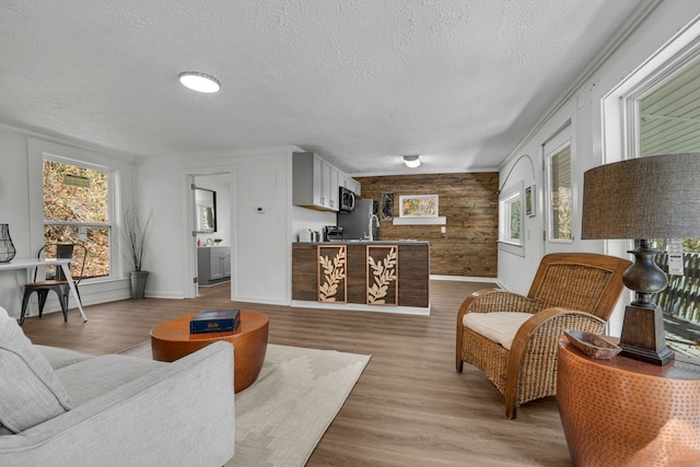 living room with hardwood / wood-style floors, a wealth of natural light, and a textured ceiling