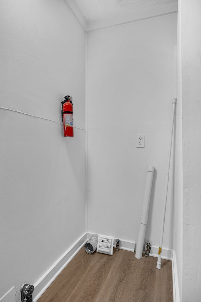 clothes washing area featuring hardwood / wood-style floors