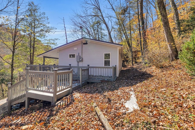 rear view of property featuring a deck