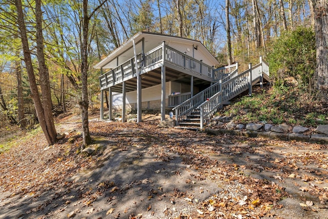 rear view of house featuring a deck