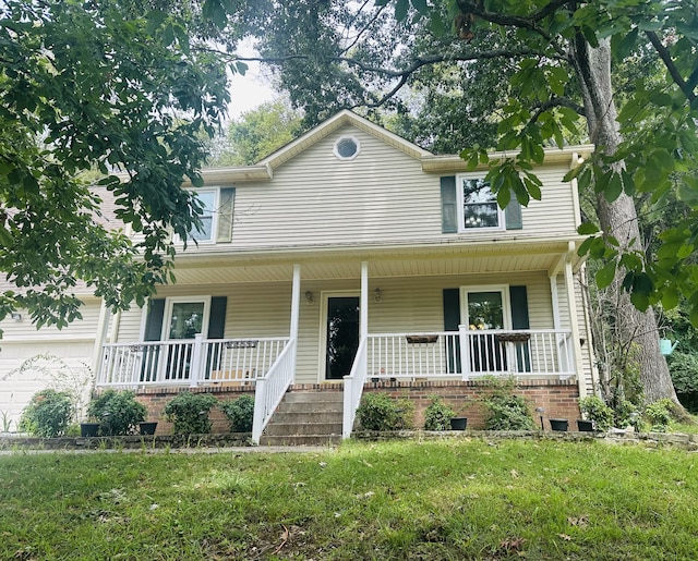 view of front of home with a front yard and a porch