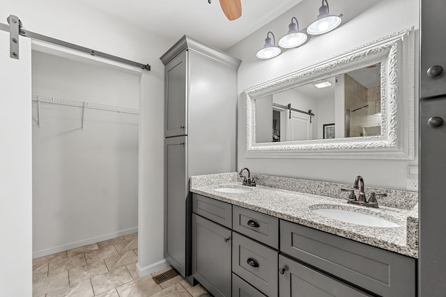 bathroom with ceiling fan and vanity