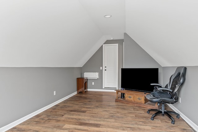 office with lofted ceiling and hardwood / wood-style floors