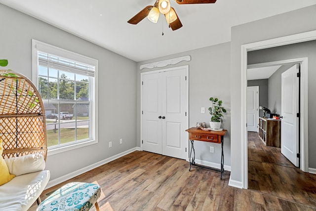 interior space with ceiling fan and dark hardwood / wood-style flooring