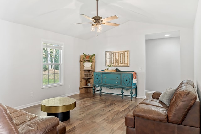 living room featuring wood-type flooring, vaulted ceiling, and ceiling fan