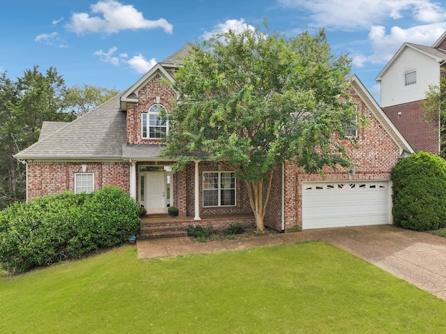 front facade with a front yard and a garage