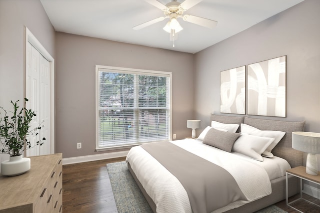 bedroom with a closet, ceiling fan, and dark hardwood / wood-style flooring