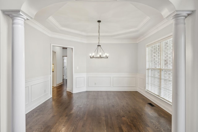 unfurnished dining area featuring a tray ceiling, crown molding, dark hardwood / wood-style flooring, and a notable chandelier