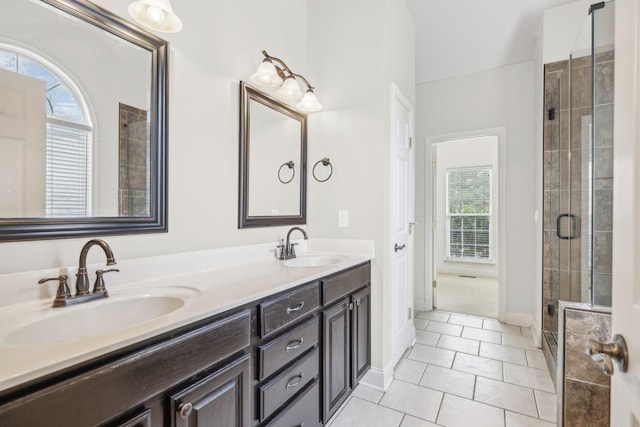 bathroom featuring tile patterned floors, a wealth of natural light, vanity, and a shower with shower door