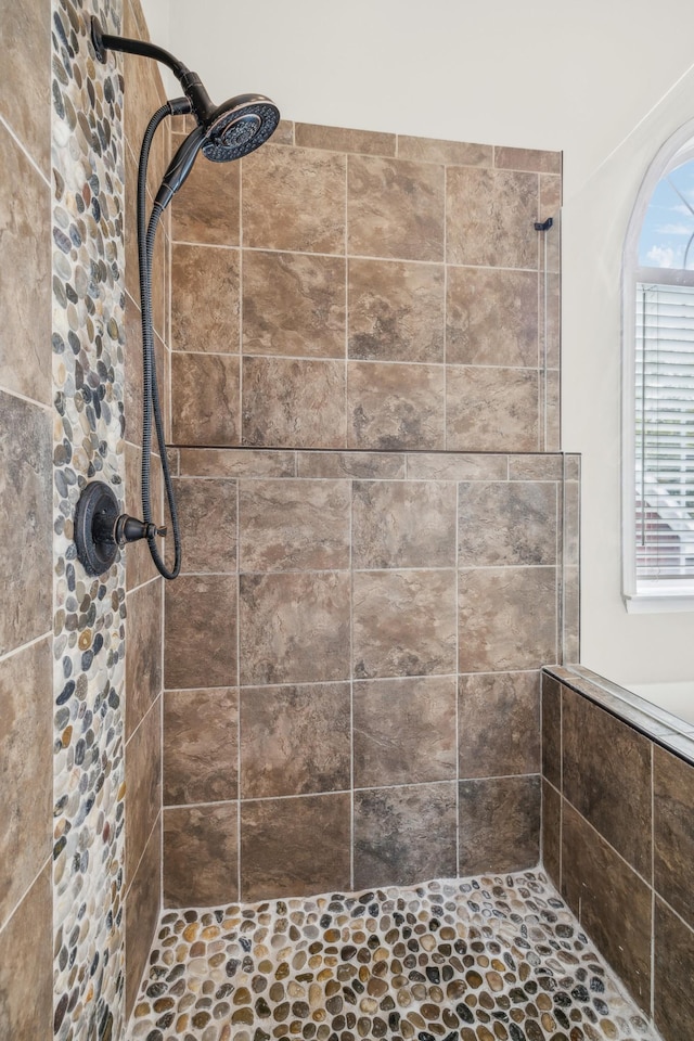 bathroom with tiled shower