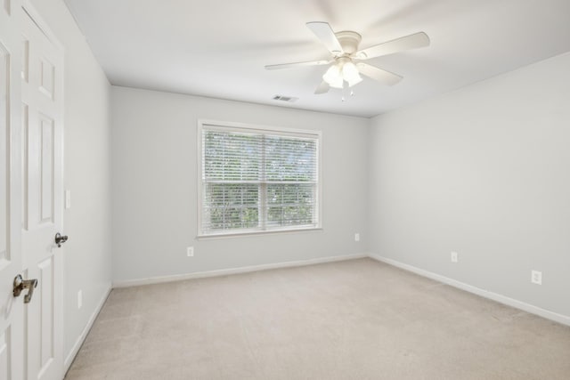 unfurnished room with ceiling fan and light carpet