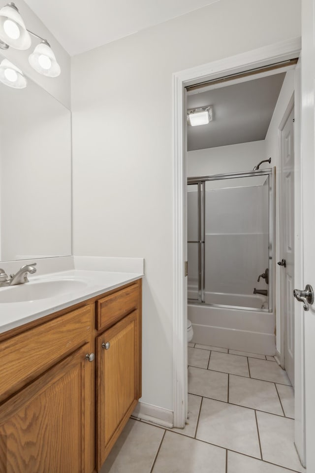 full bathroom with tile patterned flooring, vanity, toilet, and shower / bath combination with glass door