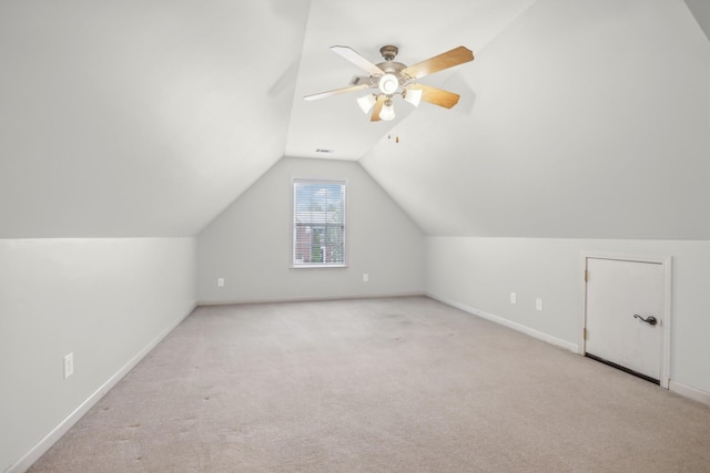 additional living space with light carpet, ceiling fan, and lofted ceiling