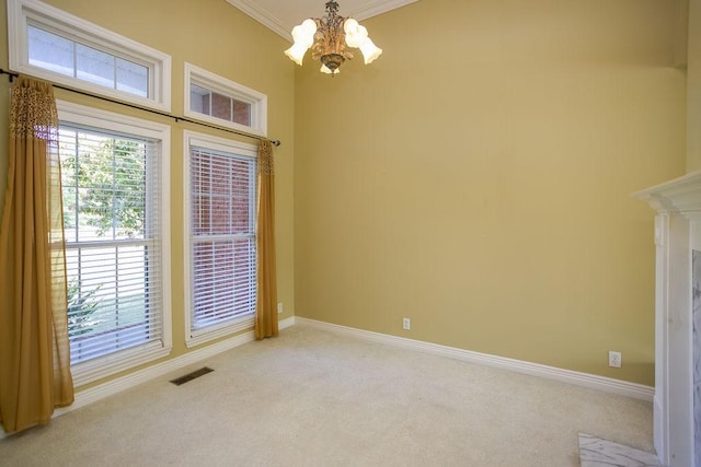 empty room with visible vents, crown molding, baseboards, light carpet, and an inviting chandelier