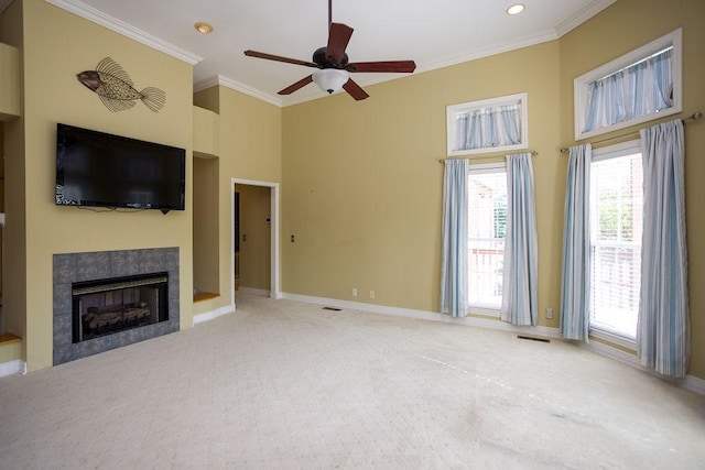unfurnished living room featuring a ceiling fan, ornamental molding, carpet, and visible vents