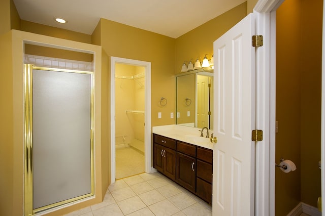 bathroom with vanity, walk in shower, and tile patterned flooring