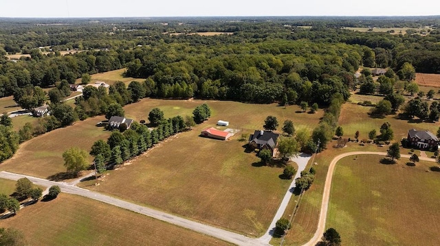 birds eye view of property featuring a wooded view and a rural view