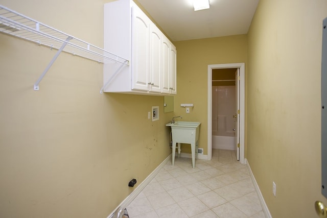 clothes washing area featuring washer hookup and cabinets