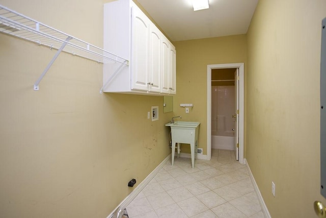 laundry area featuring baseboards, cabinet space, light tile patterned floors, and hookup for a washing machine