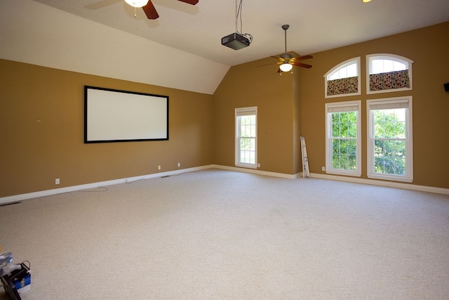 carpeted home theater room featuring ceiling fan and vaulted ceiling