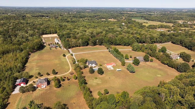 bird's eye view with a wooded view