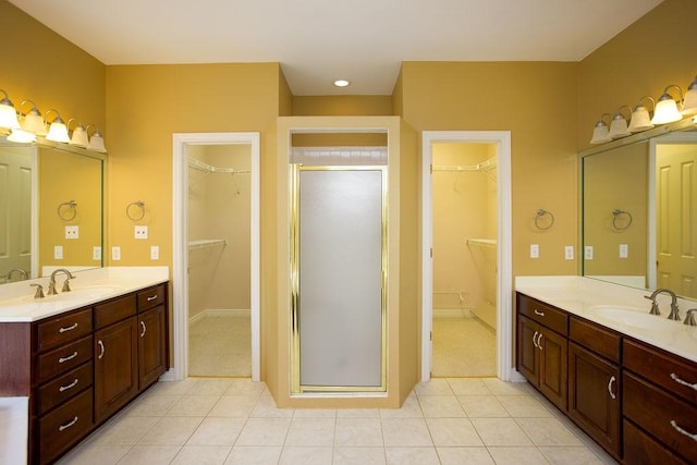 bathroom featuring a sink, two vanities, and a shower stall
