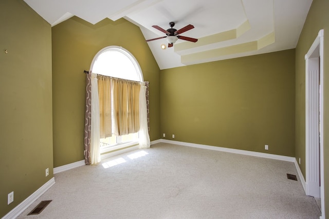 carpeted spare room with lofted ceiling and ceiling fan