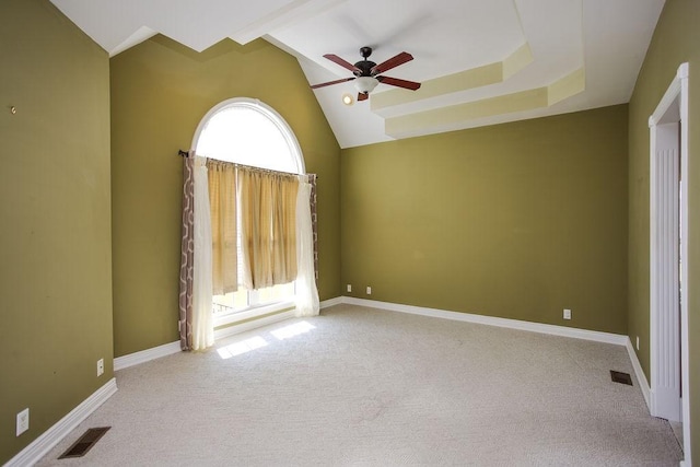 carpeted empty room with baseboards, visible vents, and a ceiling fan
