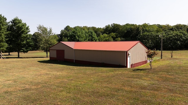 exterior space featuring a yard, a rural view, and an outdoor structure