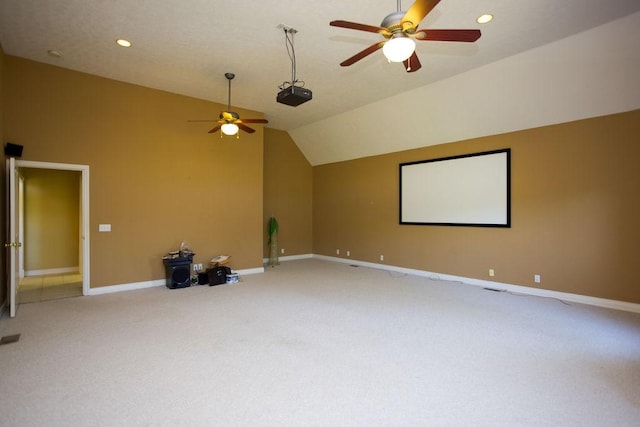 home theater with vaulted ceiling, recessed lighting, baseboards, ceiling fan, and light carpet
