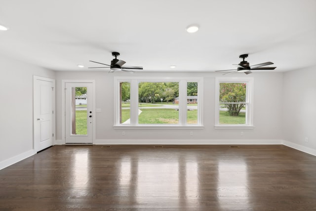 spare room featuring ceiling fan and dark hardwood / wood-style flooring