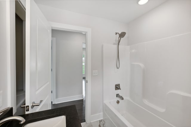 bathroom featuring hardwood / wood-style flooring, shower / bathing tub combination, and vanity