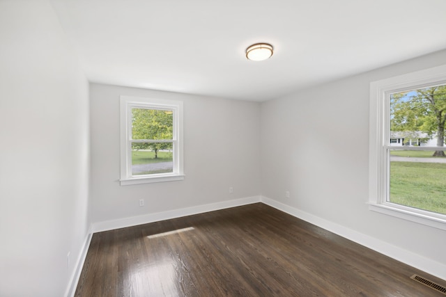 empty room with dark wood-type flooring