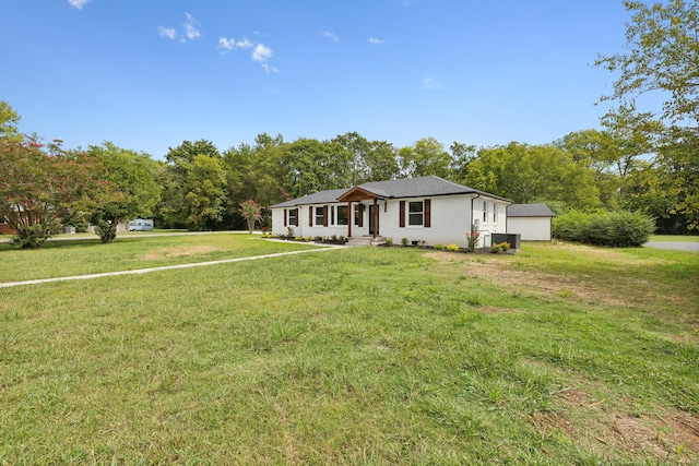 single story home with central air condition unit, an outdoor structure, and a front lawn