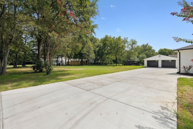 exterior space with an outdoor structure, a garage, and a lawn