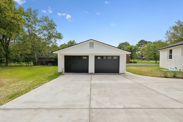 garage featuring a lawn