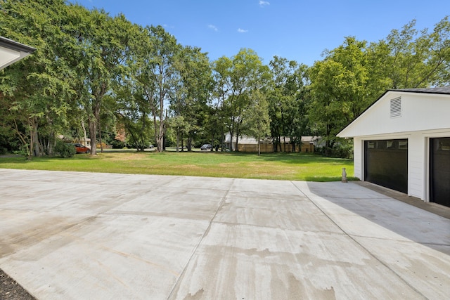 view of patio with an outbuilding and a garage