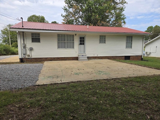 back of property featuring a lawn and a patio area