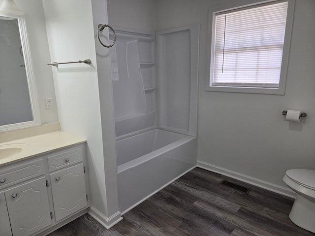 full bathroom with shower / tub combination, wood-type flooring, toilet, and vanity