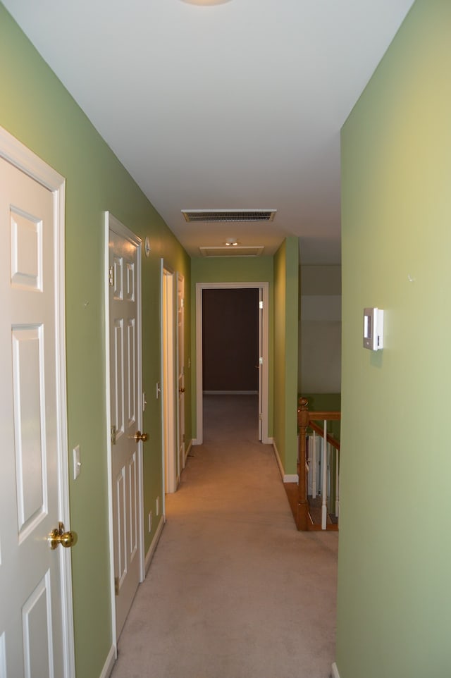 hallway with light colored carpet