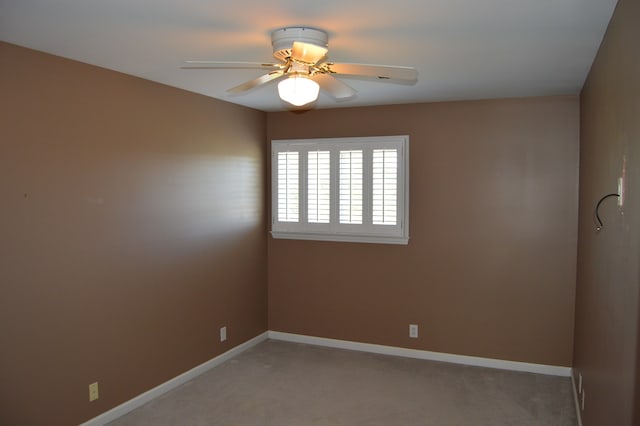 empty room with carpet flooring and ceiling fan