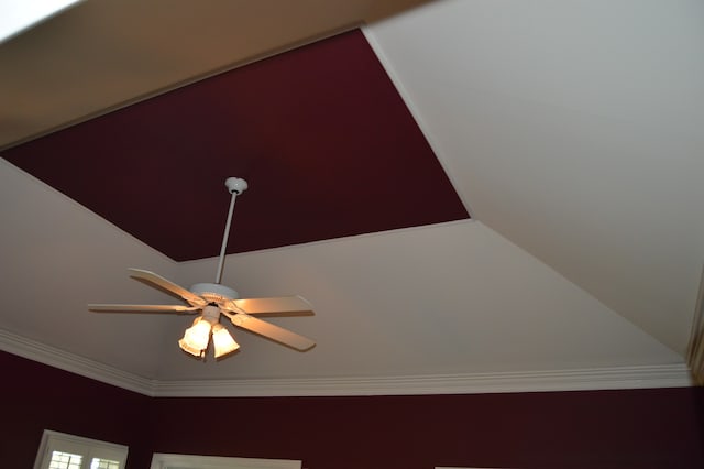 interior details featuring crown molding and ceiling fan