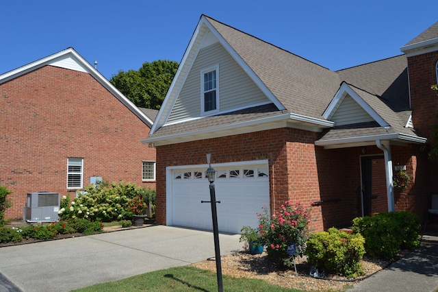 view of front of home with central AC and a garage