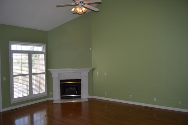 unfurnished living room with lofted ceiling, ceiling fan, hardwood / wood-style flooring, and a fireplace